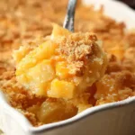 Close-up of cheesy pineapple casserole with golden cracker topping