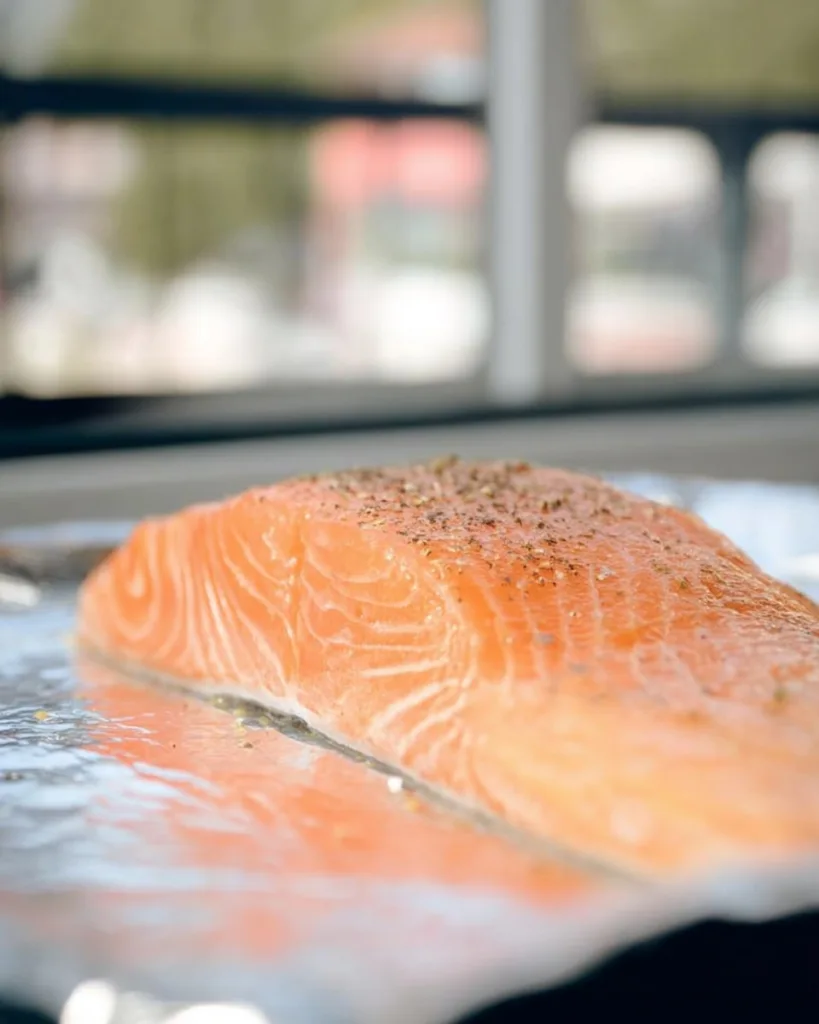 raw salmon filet seasoned and ready for baking