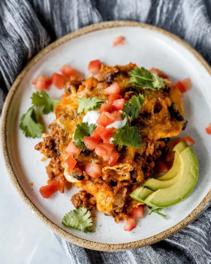 Single serving of taco casserole with avocado and fresh cilantro