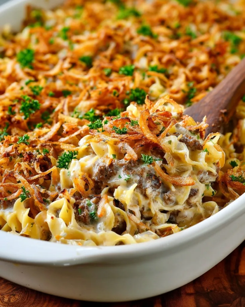 Creamy French Onion Beef Casserole in baking dish with parsley garnish